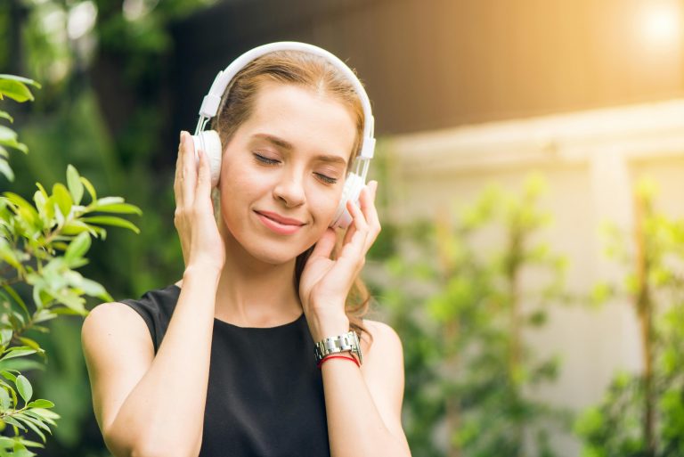 Teen girl listening to music in music therapy.