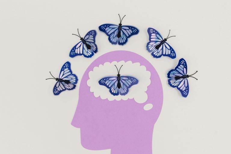 Silhouette of human head with butterflies emerging from the mind. Brain Insights. What is a Neuropsychologist and How Can They Help You?
